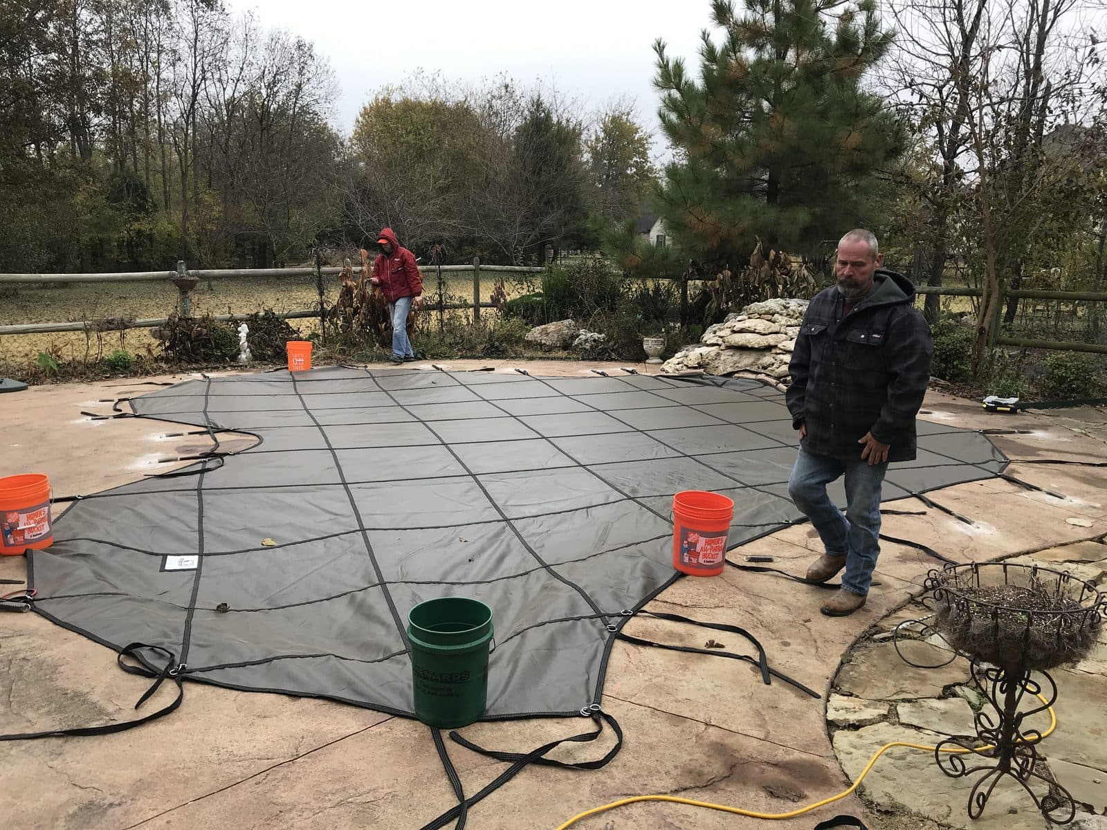 Installing a custom inground pool safety cover on an Oklahoma pool deck