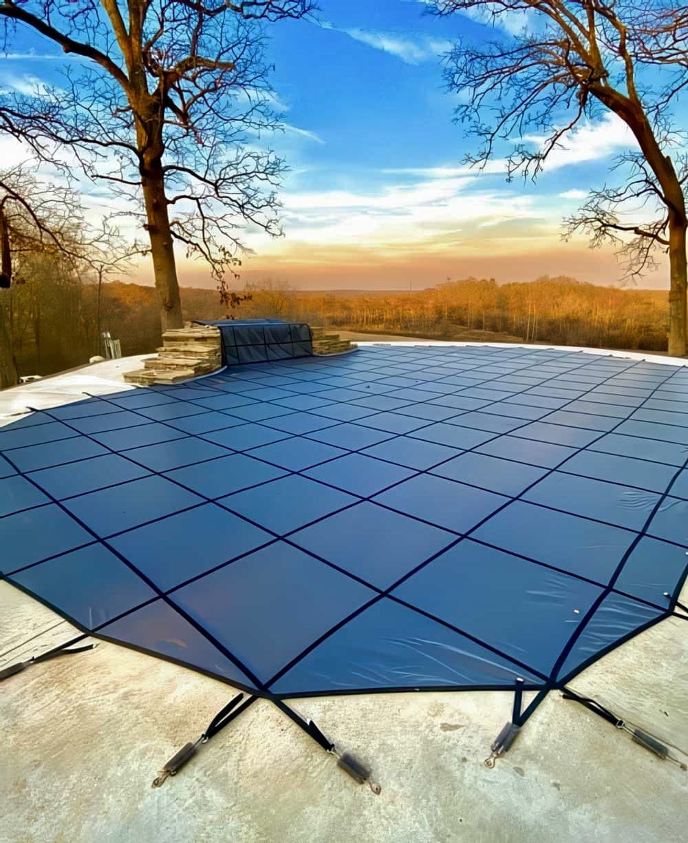 Inground pool safety cover installed for winter on an Oklahoma pool at sunset