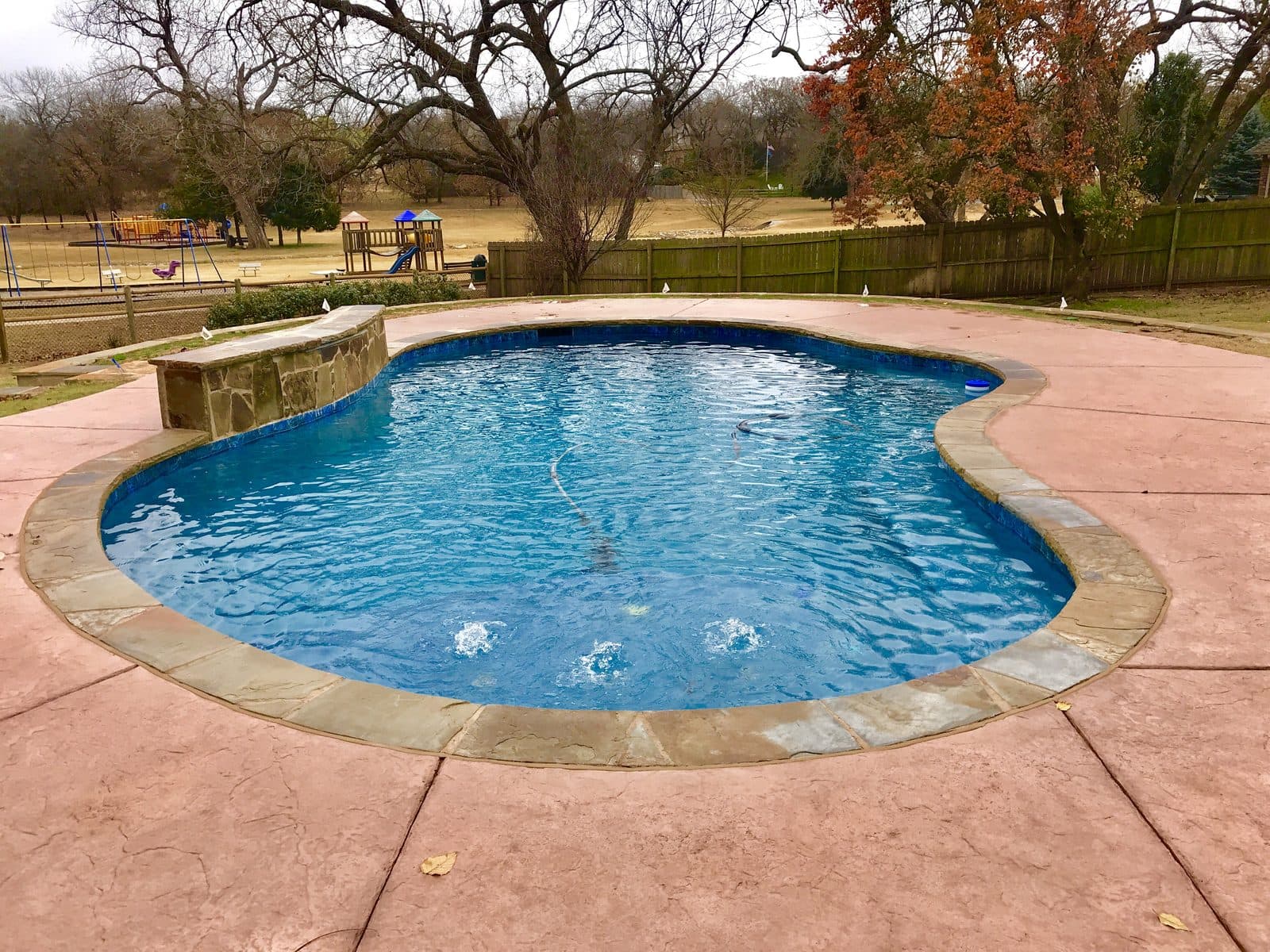 Freeform inground pool opened and running clear for spring in Central Oklahoma